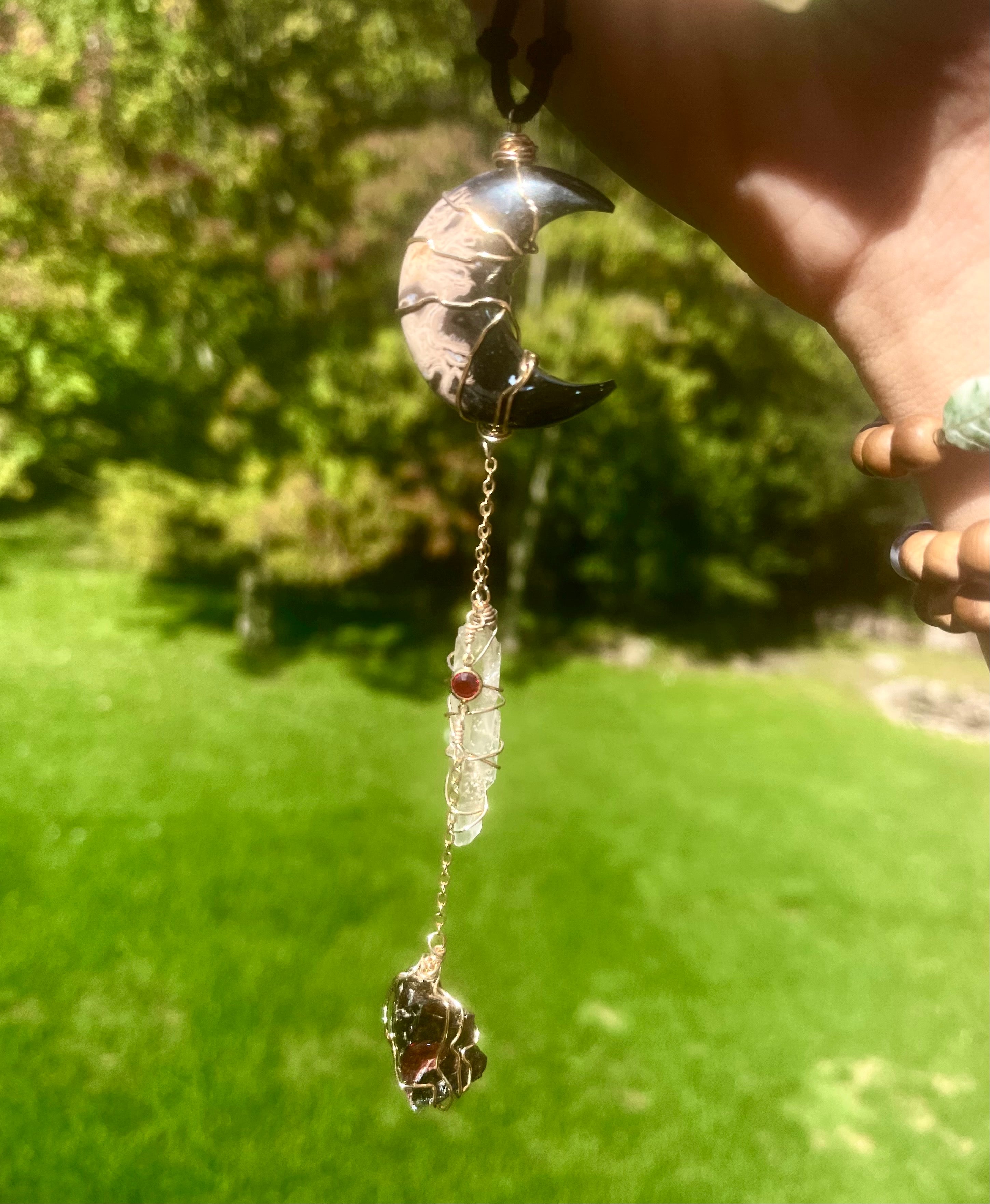 fossilized palm root moon garnet protection dangle